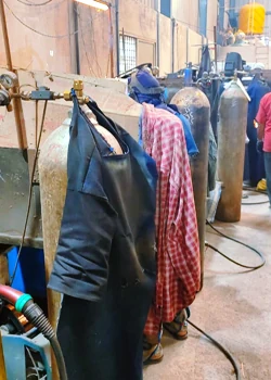 MIG welding stations with welding aprons and gas cylinders