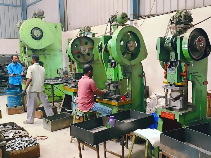 Karthikeya Engineering press shop with a row of mechanical power presses and operators