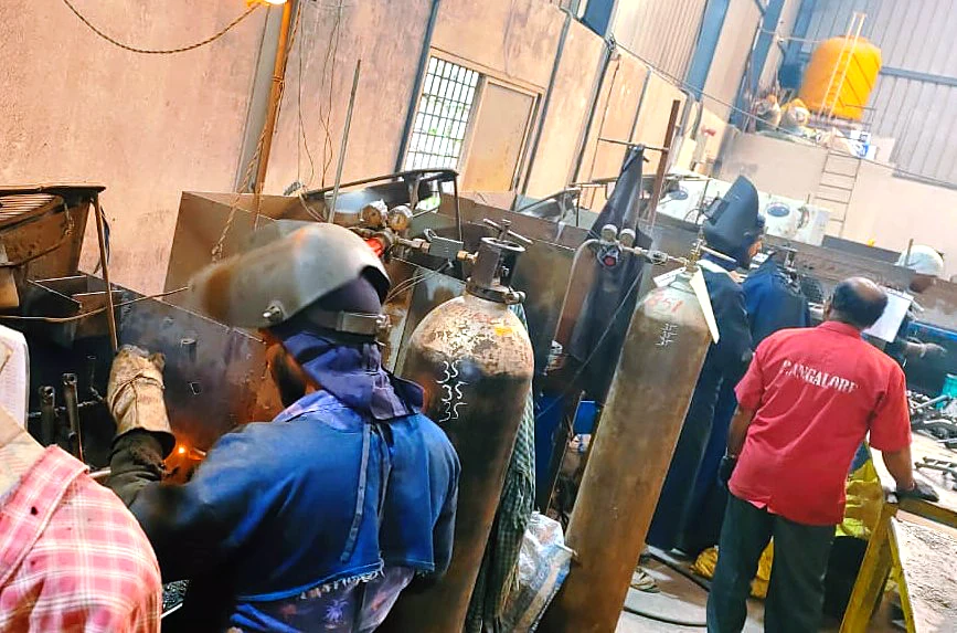 Welders at MIG welding stations in the Karthikeya Engineering fabrication bay